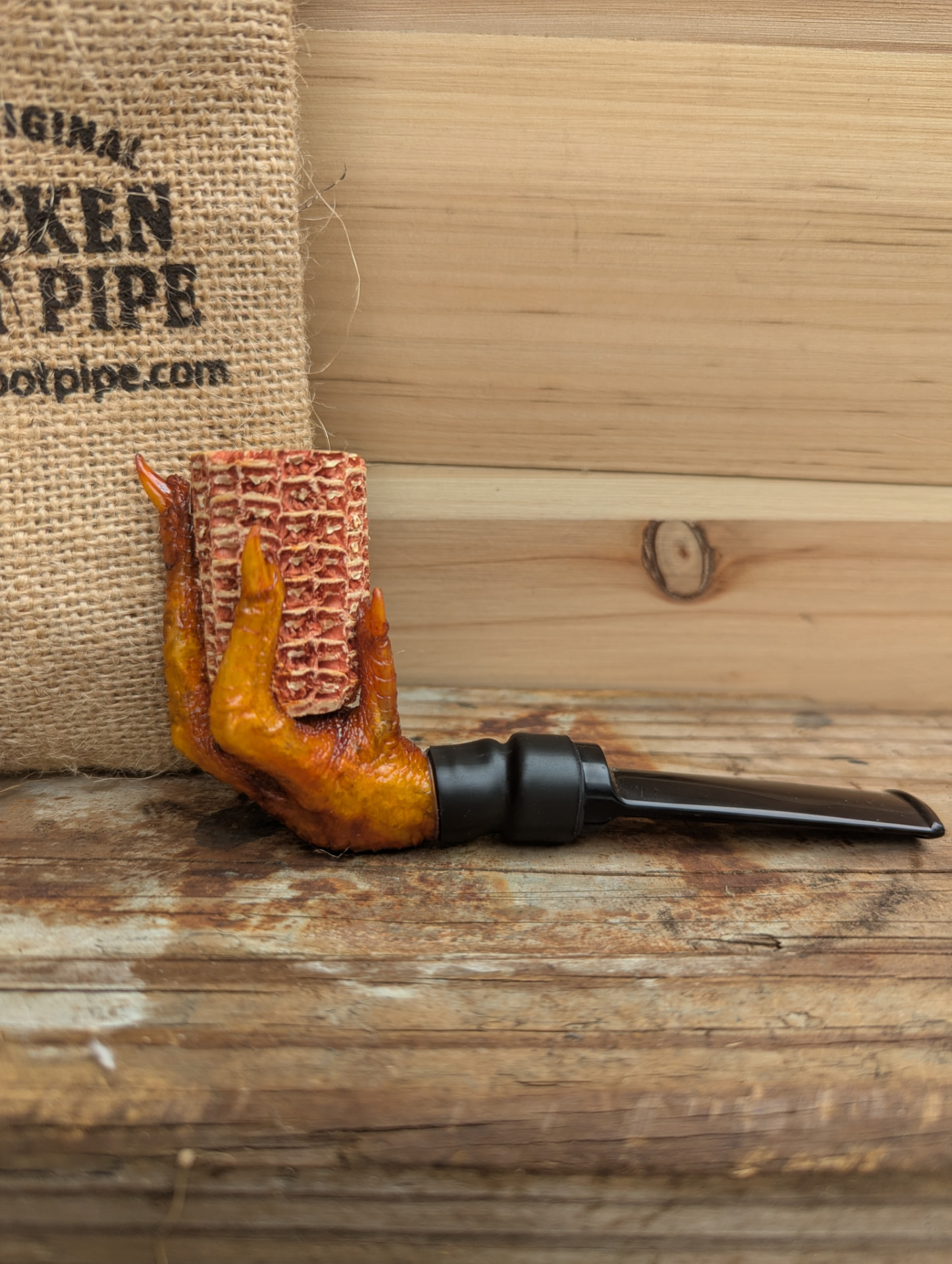 Side profile of the corncob bowl chicken foot pipe on weathered wood