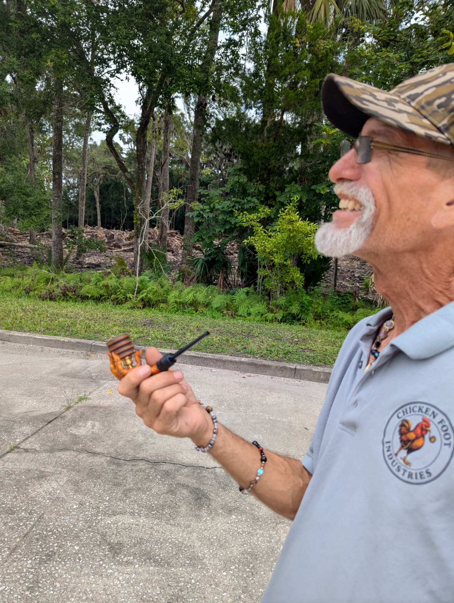 Founder holding a handmade chicken foot pipe with wooden bowl in Florida